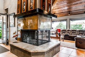 Three sided fireplace. One side faces bar and other faces living room.