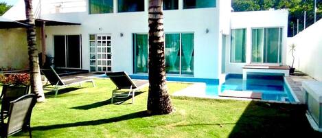 Private garden and pool with patio furniture, hamaca and grilled. 