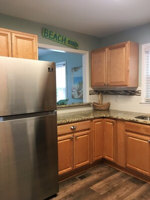 Kitchen is fully stocked with cooking utensils to create wonderful family meals.