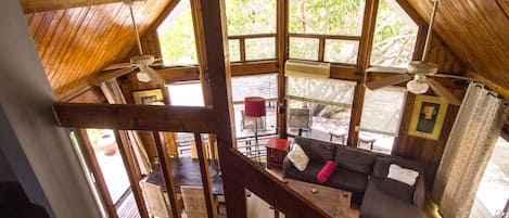 View from the loft, cedar ceiling and wall of windows facing backyard