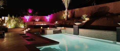 Pool at night with lounging bench