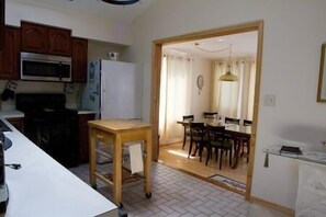 The capacious flow from Living Room to Dining Room and the Vaulted Ceiling and Skylights in the Kitchen and Living Room give a sense of spaciousness to the family area.