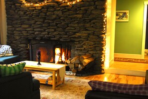 Fireplace, black pullout couch in living room.