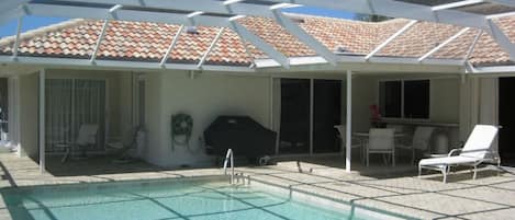 Enjoy the large south facing pool and 1700 Sq. Ft. Screened Lanai