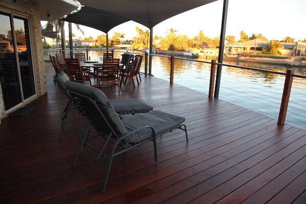 The spacious deck complete with 9 seat outdoor setting and BBQ and 2 lounges