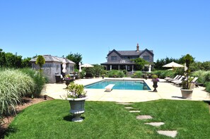 View of pool, cabana, house