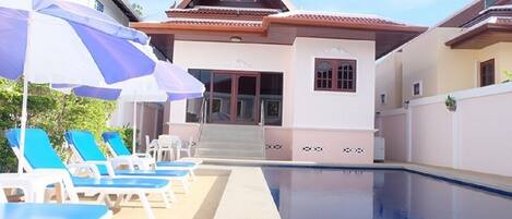 Majestic Villas 1, 2 bedroom. Rear view of villa and pool area with loungers.