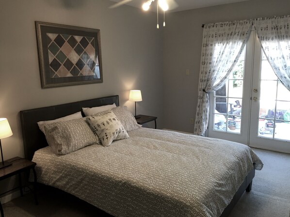 One of three Queen size bedrooms, French doors open to private patio & backyard