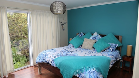 Master Bedroom- Comfortable King. View over the bush garden to reserve beyond