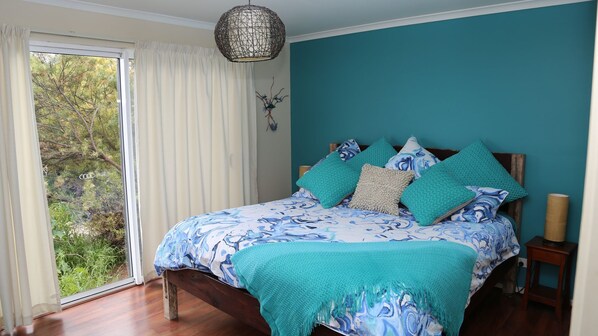 Master Bedroom- Comfortable King. View over the bush garden to reserve beyond