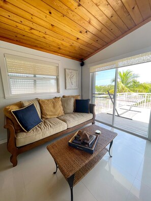 View of living room facing hammock on large deck. 