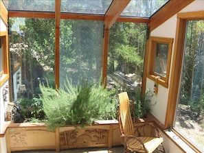 Our incredible sunroom with herb garden and large windows