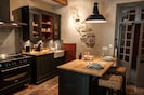 Custom design kitchen with a hint of original stone wall