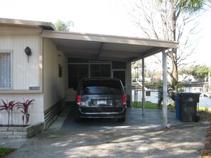 Carport with Screened Porch in front of car 