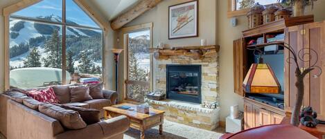 Relax in the cozy living room with outstanding views of the ski resort