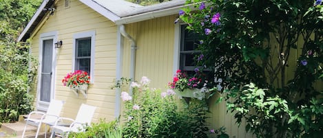 Charming cottage with flowers in bloom 