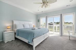 Main Bedroom (upstairs) with King bed and balcony access.