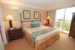 Primary bedroom with a king size bed and balcony.