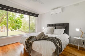 Queen bed with heating, cooling, ceiling fan and smart TV