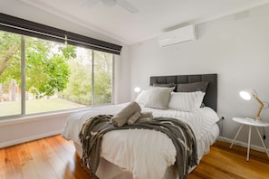 Queen bed with heating, cooling, ceiling fan and smart TV