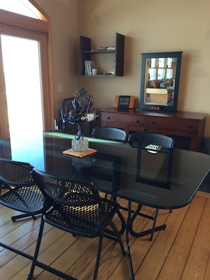 Dining room table, water views, wood flooring.