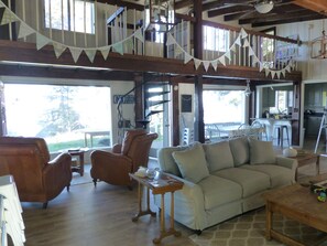 Living room showing dining area and reading chairs.  Lake views