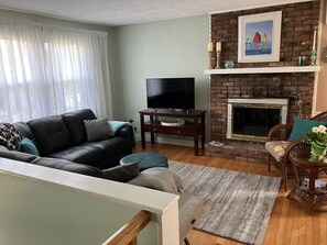 Comfy leather sofa and cozy fireplace in living room 