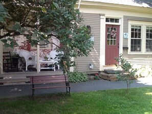 A park bench faces Tribou Park--behind that a  second porch for relaxation