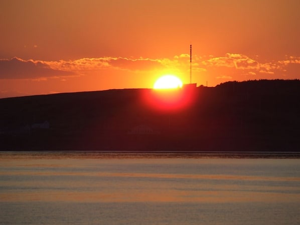             striking island sunset  through kitchen window.