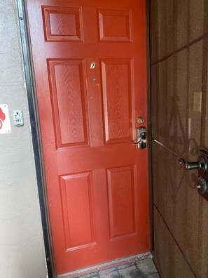Red front door with smart lock