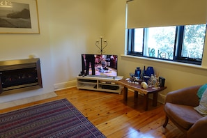 Lounge, TV, Foxtel, opening windows, lots of comfy seating, gas fire, private