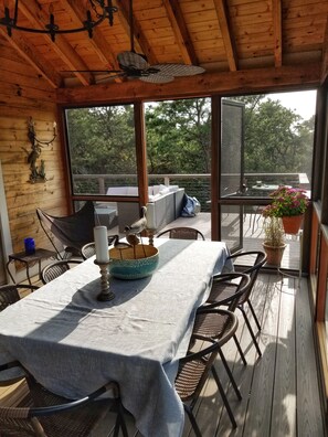The covered, screened porch is a perfect for summer dining.