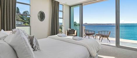 Master bedroom with stunning lake views, balcony and private ensuite bathroom