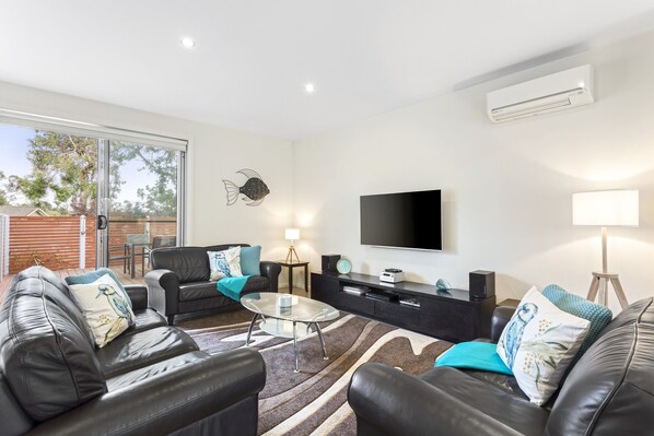 Spacious lounge with seating for 10+, looking out to front deck