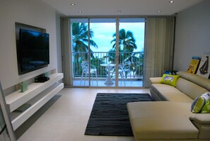 Living room and balcony, steps from beach