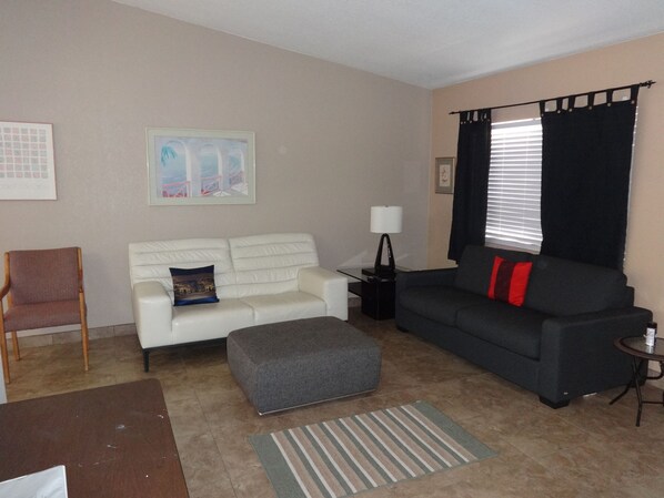 Living room includes sleeper sofa on the right.