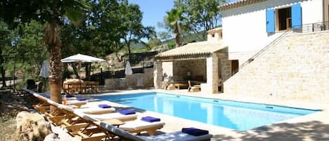 pool area with large terrace and outside fireplace