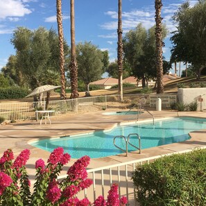 Pool #1 with adjacent hot tub is across the street from the condo.