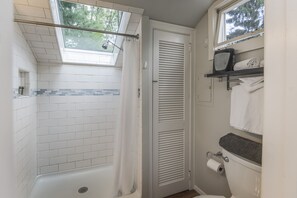 new and fabulous shower with pines above with beautiful natural light.