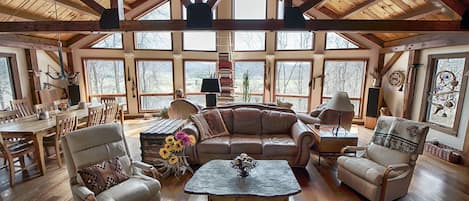 The great room with huge stone fireplace and mountain views.