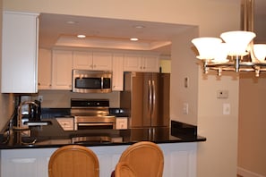 Kitchen with granite counter tops, stainless appliances, including dishwasher 