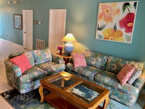 Living room with love seat and queen size sleeper sofa.