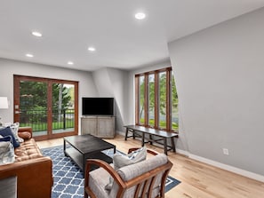 Main floor living room with south facing deck.