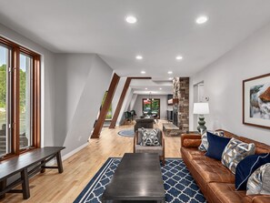Open concept living and dining with river front views and a gas fireplace.