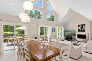 High ceiling dining room with 12 person dinner table