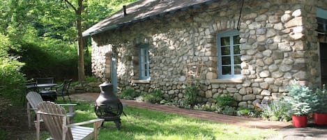 Outdoor eating area with grill and firepit