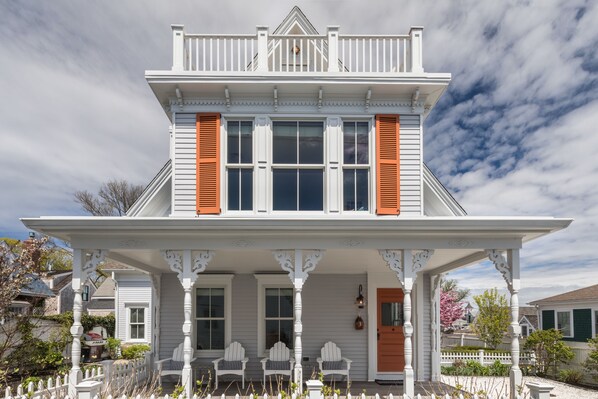 Front view with welcoming front porch and widow's walk on third level