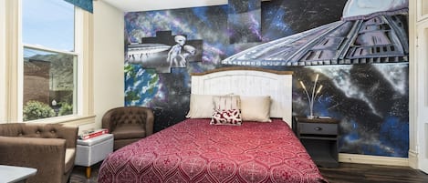 Queen bed with hand painted wall mural.