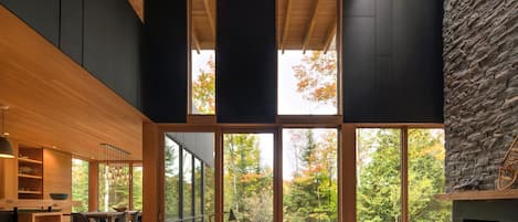 Be outdoors indoors: lake views + two-storey granite fireplace with skylight. 