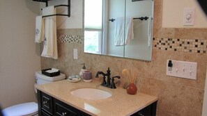 Large bathroom with tub and shower.